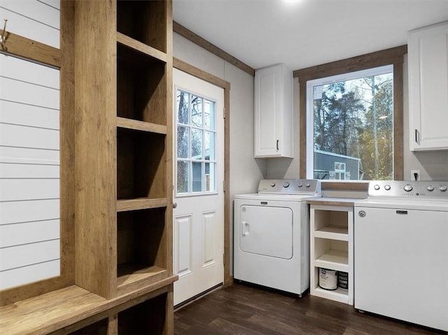 laundry room featuring dark wood-type flooring, cabinets, and washer and dryer