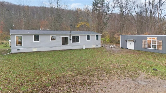 rear view of property with a yard