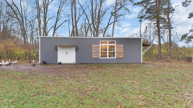 view of outbuilding with a yard