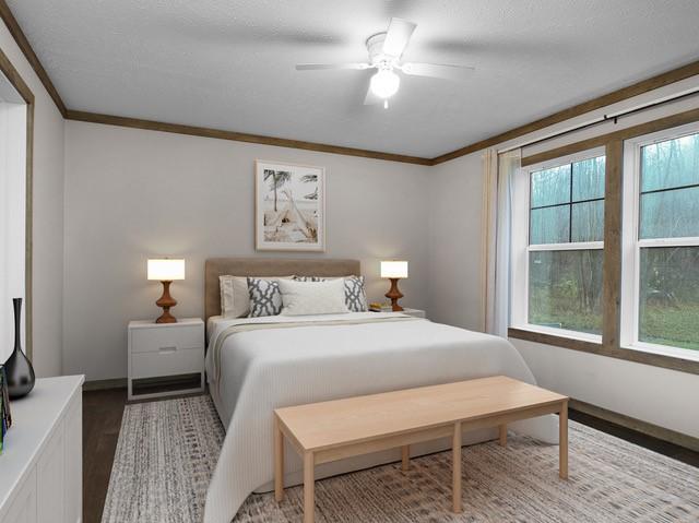 bedroom with ceiling fan, ornamental molding, and multiple windows