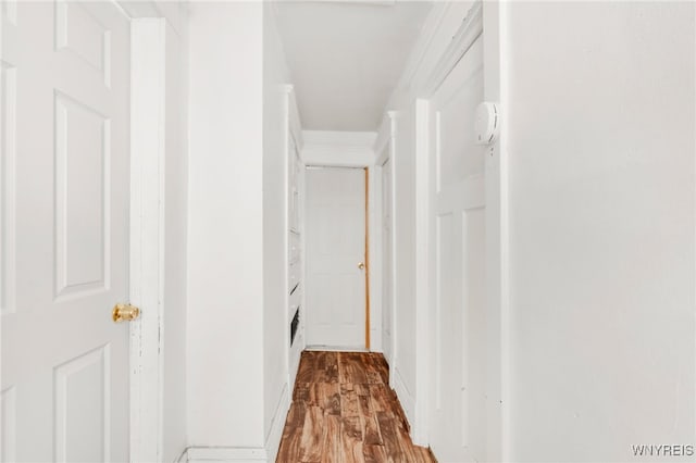 hallway with light hardwood / wood-style floors