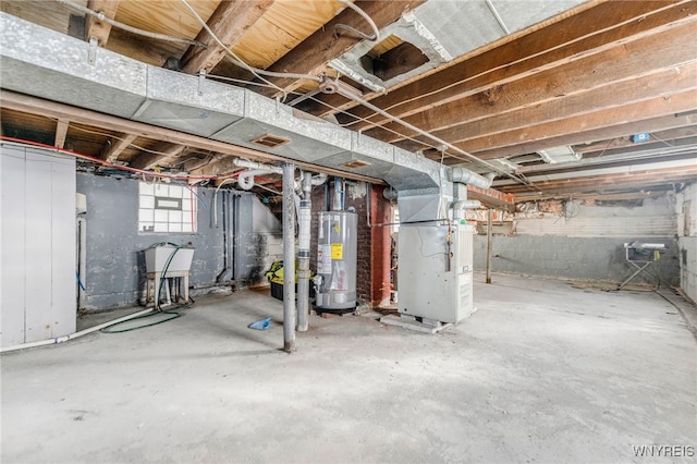 basement featuring heating unit and water heater