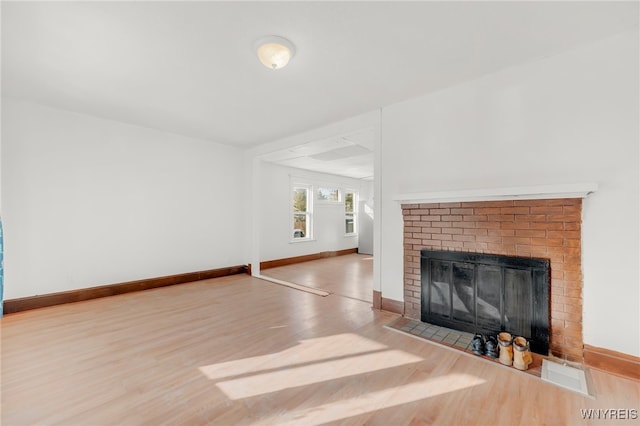 unfurnished living room with a fireplace and hardwood / wood-style flooring