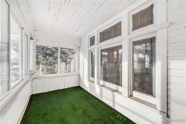 unfurnished sunroom with wood ceiling