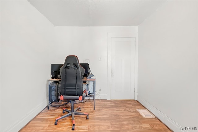 office with hardwood / wood-style flooring