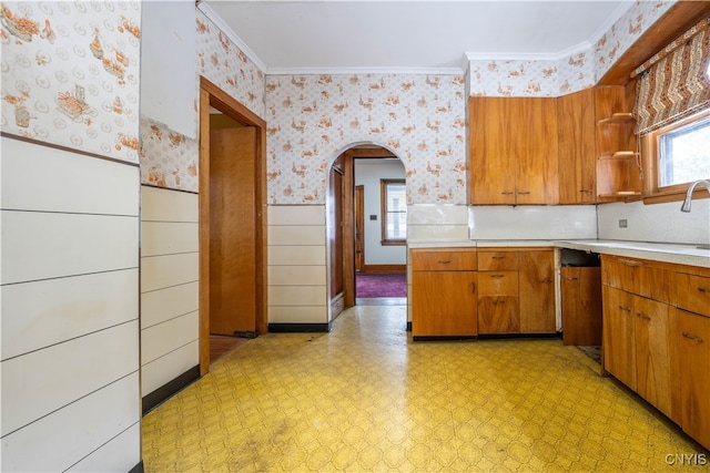 kitchen with crown molding, sink, and stainless steel dishwasher