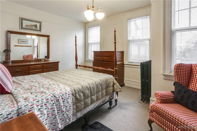 bedroom featuring a notable chandelier and carpet floors