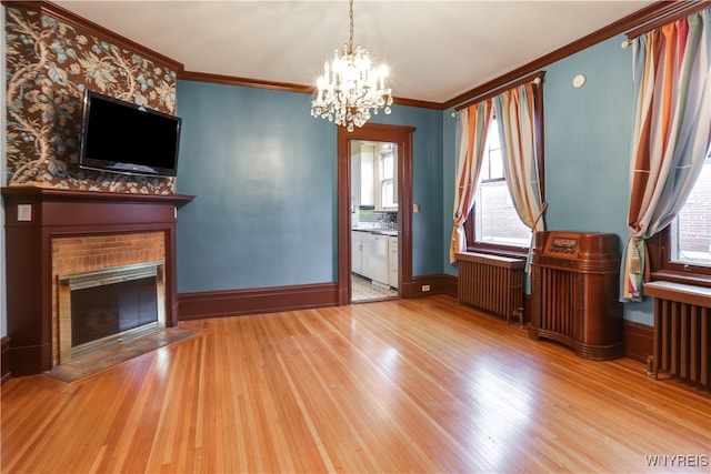 unfurnished living room featuring radiator and light wood-type flooring