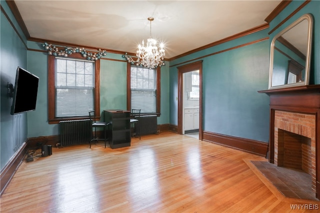 interior space with radiator heating unit, an inviting chandelier, ornamental molding, and light hardwood / wood-style flooring