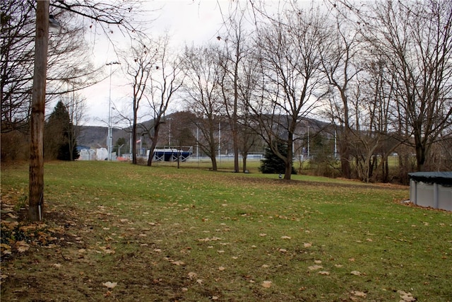 view of yard with a covered pool