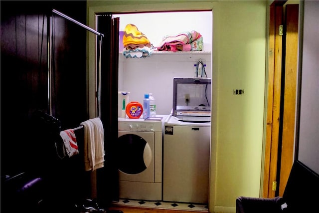 clothes washing area featuring separate washer and dryer