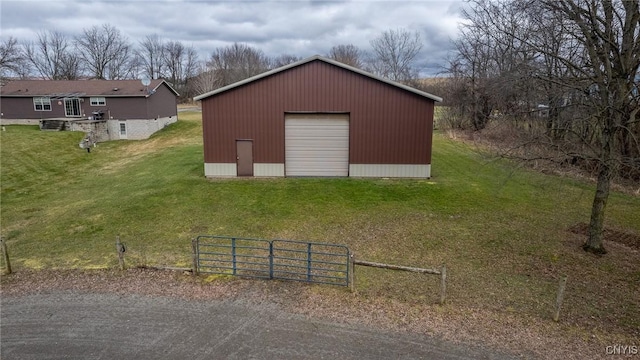 view of outdoor structure featuring a lawn and a garage