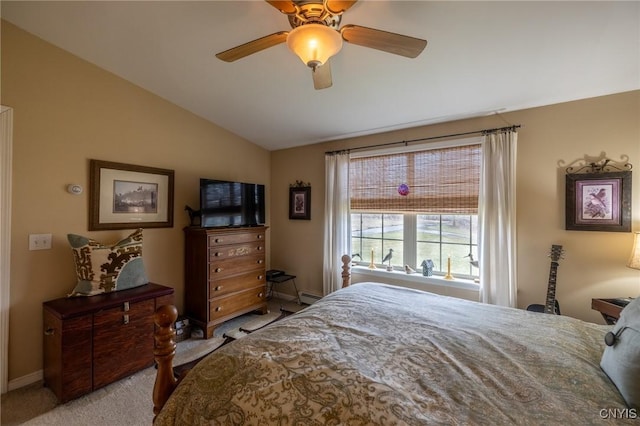 carpeted bedroom with baseboard heating, vaulted ceiling, and ceiling fan