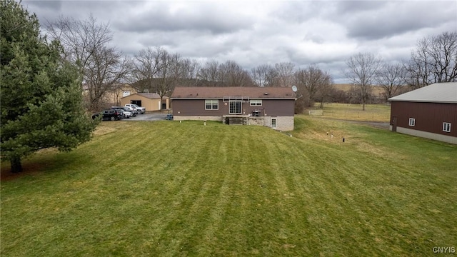 rear view of property with a yard