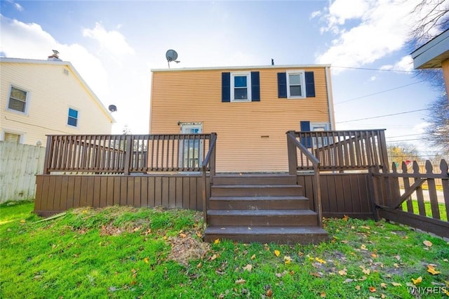 back of house featuring a deck and a yard