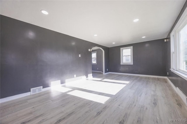 empty room with a healthy amount of sunlight and light wood-type flooring