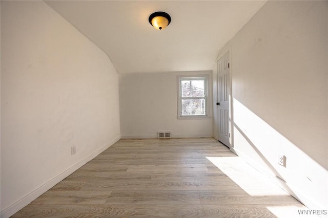 bonus room featuring light hardwood / wood-style flooring and vaulted ceiling