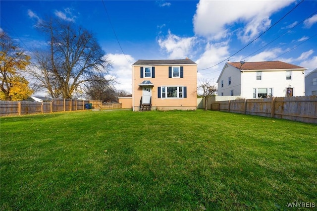 back of house featuring a yard