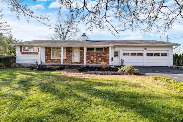 ranch-style home featuring a garage and a front lawn