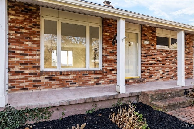 entrance to property featuring covered porch