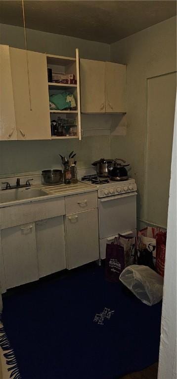 kitchen with white range with gas stovetop and sink