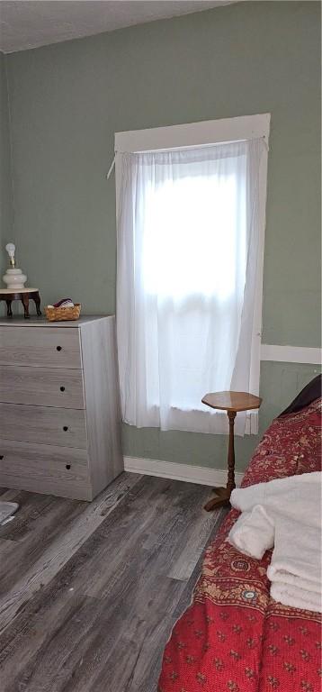 bedroom with dark wood-type flooring