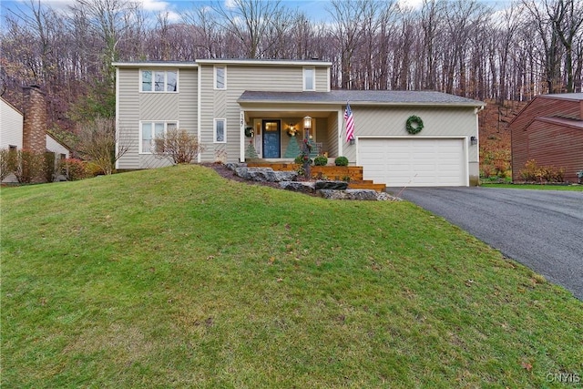 view of property with a front yard, a porch, and a garage