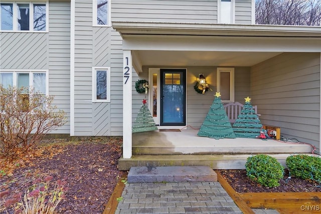 view of exterior entry with covered porch