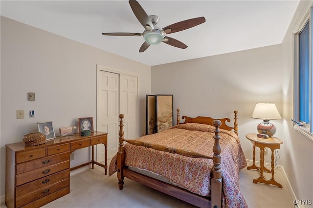 carpeted bedroom featuring a closet and ceiling fan