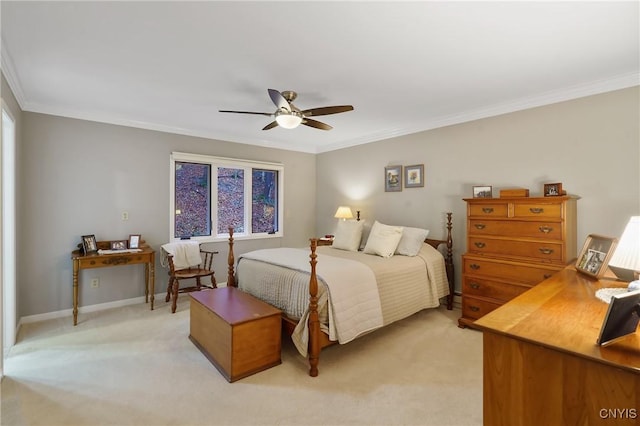 carpeted bedroom featuring ceiling fan and crown molding