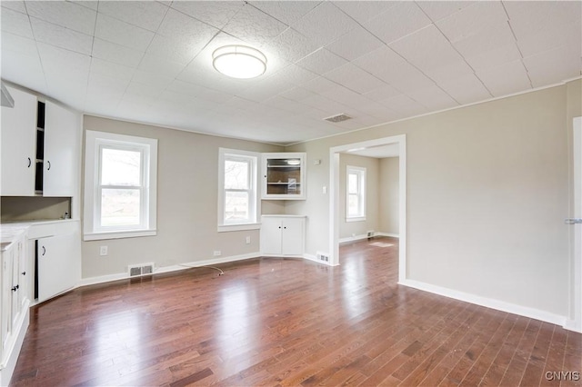 unfurnished living room featuring hardwood / wood-style flooring