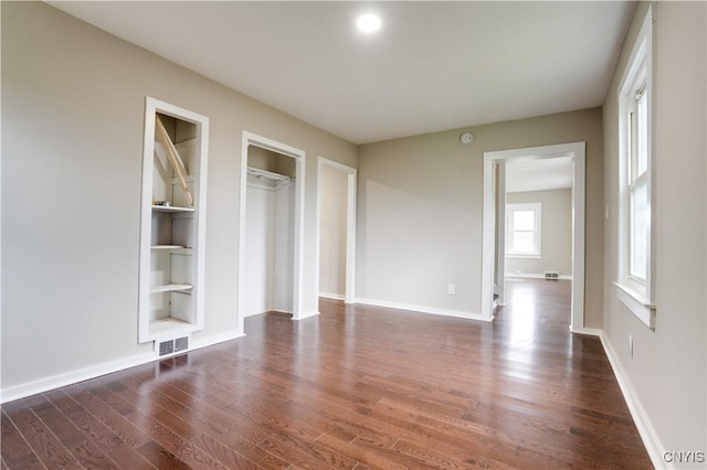 unfurnished bedroom with dark hardwood / wood-style floors