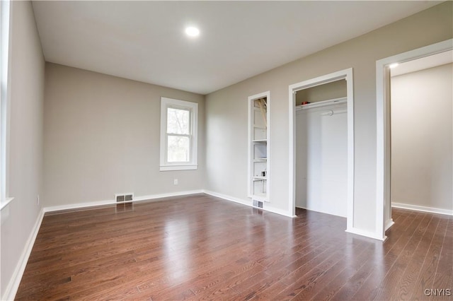 unfurnished bedroom featuring dark hardwood / wood-style floors