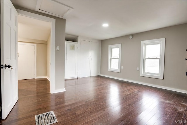 unfurnished room with dark wood-type flooring