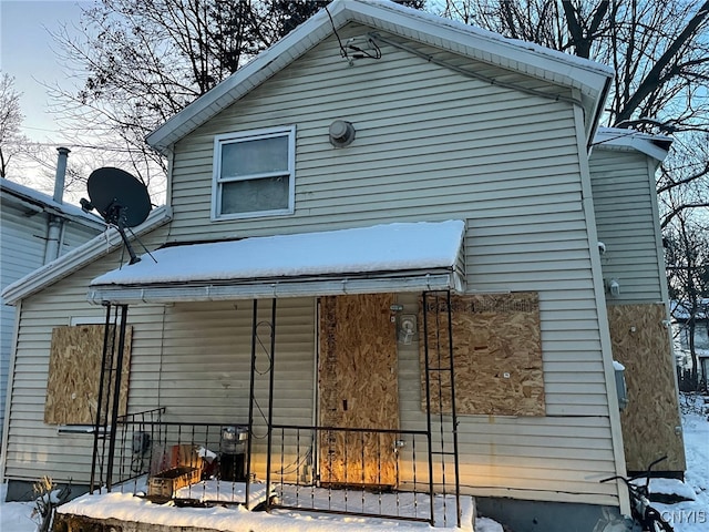 view of snow covered rear of property