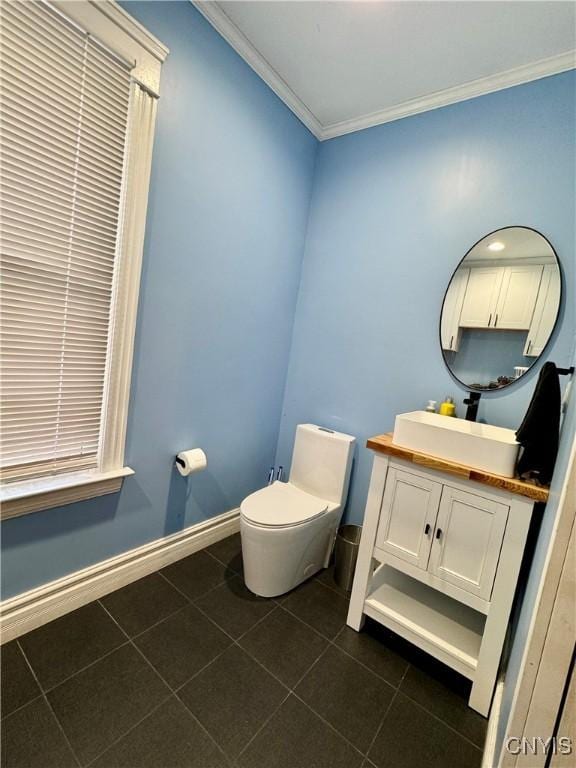 bathroom with tile patterned flooring, vanity, toilet, and ornamental molding