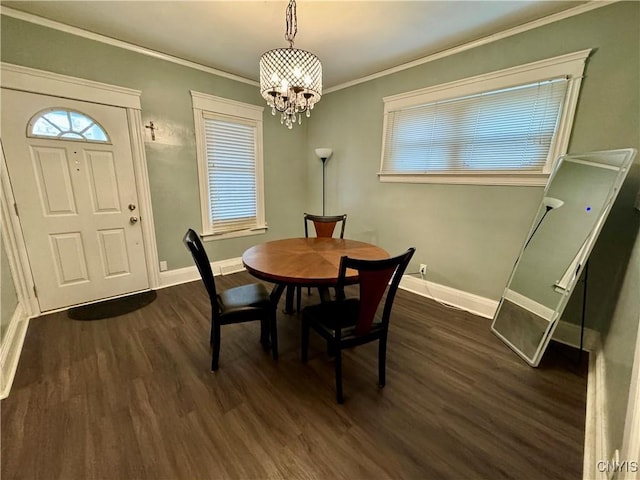 dining area featuring a chandelier, dark hardwood / wood-style floors, and ornamental molding