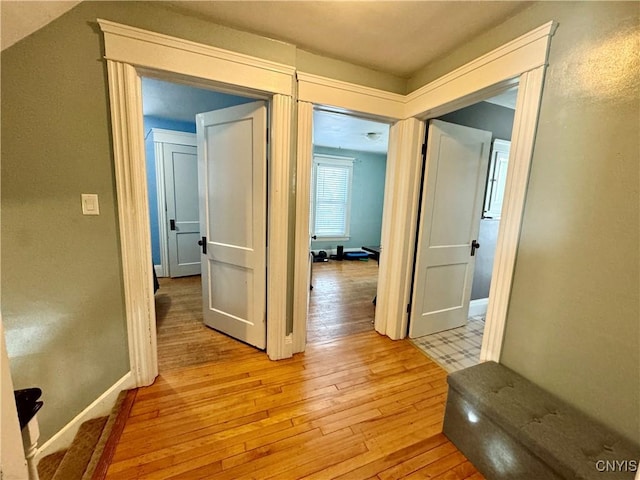 corridor with light hardwood / wood-style floors