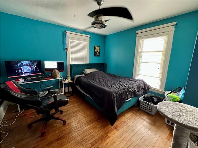 bedroom featuring hardwood / wood-style flooring and ceiling fan