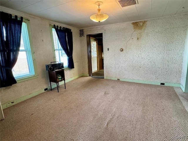 carpeted spare room with crown molding