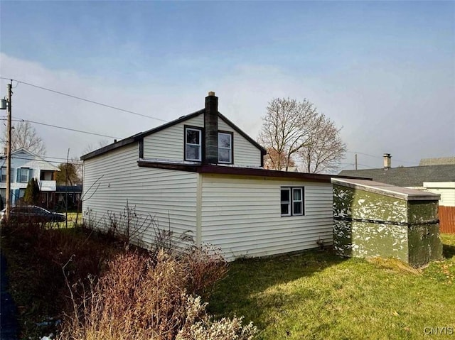 view of side of home featuring a yard