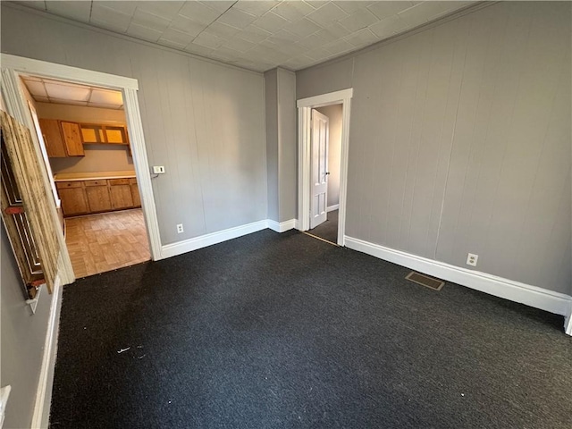 spare room with dark parquet flooring