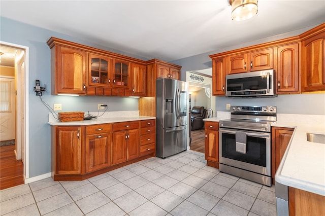 kitchen featuring light tile patterned flooring and stainless steel appliances