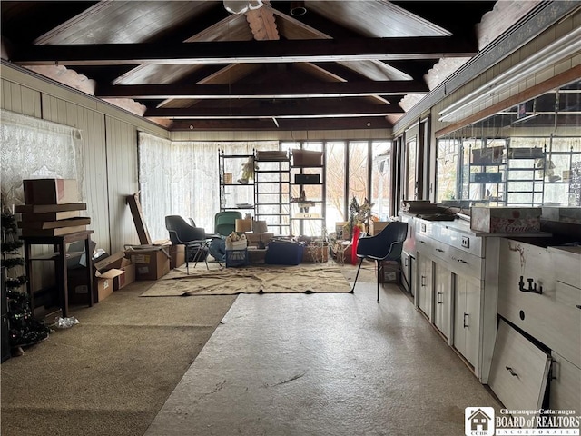 miscellaneous room with lofted ceiling with beams and light colored carpet