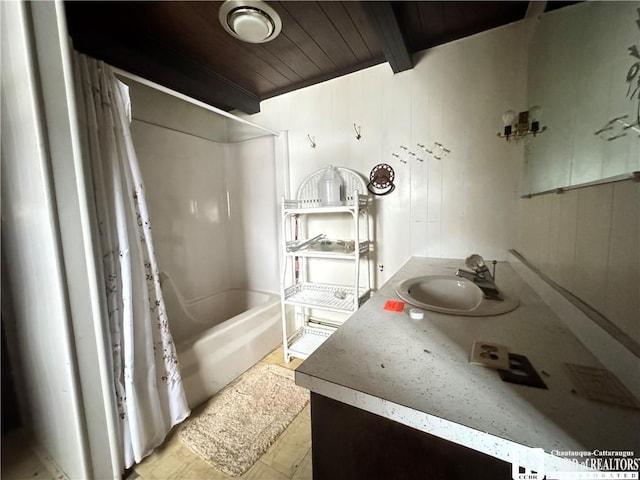 bathroom featuring vanity, beamed ceiling, shower / tub combo with curtain, wood walls, and wood ceiling