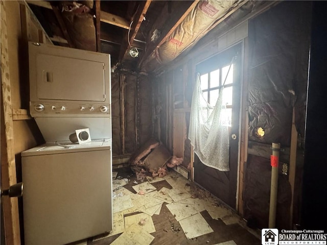 laundry area featuring stacked washer / drying machine