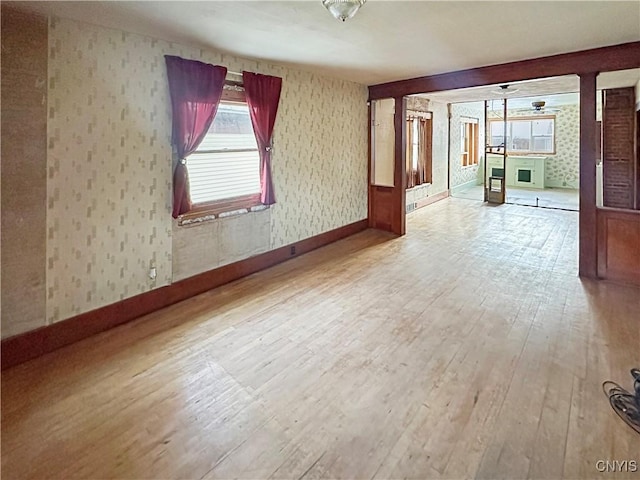 spare room with ceiling fan and wood-type flooring