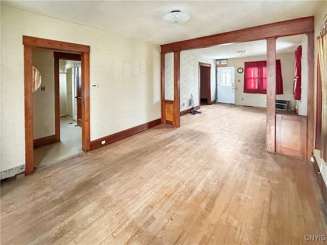 interior space featuring a wall mounted AC and light hardwood / wood-style flooring