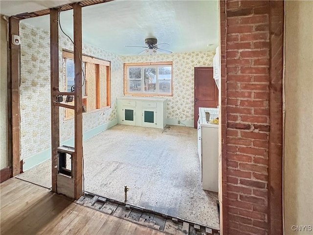 unfurnished living room with hardwood / wood-style floors and ceiling fan