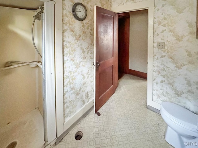 bathroom with toilet and a shower